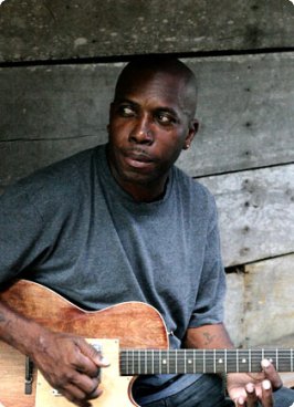 Andy Palacio holding his guitar